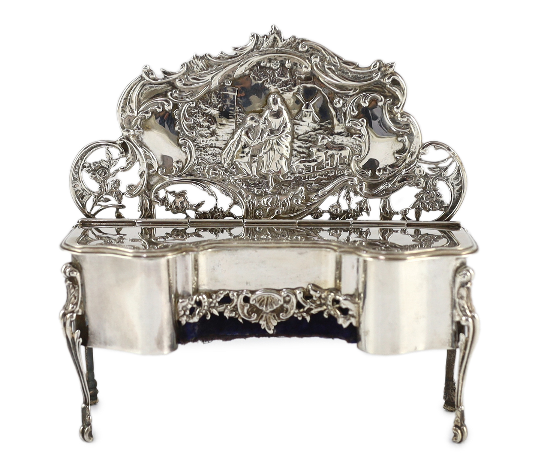 An Edwardian embossed silver novelty trinket box, modelled as a dressing table with raised back, on cabriole legs, by William Comyns